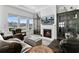 Cozy living room featuring leather seating, a fireplace, and views of the lake at 552 Marsh Cv Cir, Summerville, SC 29486
