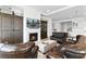 Comfortable living room featuring a fireplace, leather seating, and a view of the kitchen at 552 Marsh Cv Cir, Summerville, SC 29486