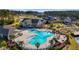 Community pool with ample seating, palm trees, and a clubhouse enhance resort-style living at 552 Marsh Cv Cir, Summerville, SC 29486