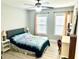 Bedroom with two windows, side tables, a bed with a blue flower blanket and a vanity desk and chair at 565 Mountain Laurel Cir, Goose Creek, SC 29445