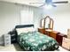 Bedroom with a bed covered with a floral quilt, a ceiling fan, and a three-panel lighted vanity mirror at 565 Mountain Laurel Cir, Goose Creek, SC 29445