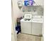 Laundry room featuring a washing machine, dryer, tiled floor, and laundry supply storage at 565 Mountain Laurel Cir, Goose Creek, SC 29445