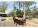 Charming back deck with dining area, overlooking a lush yard with a stylish shed at 639 Bridlewood Ln, Mount Pleasant, SC 29464