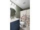 Stylish bathroom with an accent wall, gold mirror, and decorative shower curtain at 639 Bridlewood Ln, Mount Pleasant, SC 29464