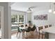 Bright dining area with large window, modern light fixture, wood table, and seating for six at 639 Bridlewood Ln, Mount Pleasant, SC 29464