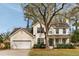 Attractive two-story home with a well-manicured lawn, a covered porch, and an attached two-car garage at 639 Bridlewood Ln, Mount Pleasant, SC 29464