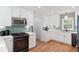 Updated kitchen with stainless steel microwave, black gas range, and modern white cabinetry at 639 Bridlewood Ln, Mount Pleasant, SC 29464