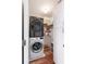 Convenient laundry room with stacked washer and dryer, plus ample storage shelving and cabinets at 639 Bridlewood Ln, Mount Pleasant, SC 29464