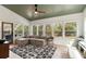 Bright sun room with lots of windows and a large sectional sofa with decorative rug at 639 Bridlewood Ln, Mount Pleasant, SC 29464