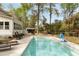 Beautiful in-ground swimming pool surrounded by a deck, rocking chairs, and a well-maintained lawn at 639 Bridlewood Ln, Mount Pleasant, SC 29464