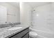 Bathroom featuring granite counters, a white tub and shower combination with a matching toilet at 7787 Montview Rd, North Charleston, SC 29418