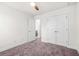 Neutral bedroom featuring carpet floors, a ceiling fan, and a closet with lots of storage space at 7787 Montview Rd, North Charleston, SC 29418