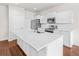Bright kitchen features stainless steel appliances, white cabinets, a large island, and hardwood floors at 7787 Montview Rd, North Charleston, SC 29418