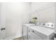 Bright laundry room with Maytag washer and dryer and ample storage space with the wire shelving above at 7787 Montview Rd, North Charleston, SC 29418