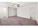 Spacious bedroom with a ceiling fan and an ensuite bathroom featuring a tiled shower and a soaking tub at 7787 Montview Rd, North Charleston, SC 29418
