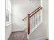 Carpeted stairs with white railing and wooden trim lead to the upper level of the home at 7787 Montview Rd, North Charleston, SC 29418