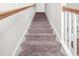 Carpeted stairs with white railing and wooden trim lead to the upper level of the home at 7787 Montview Rd, North Charleston, SC 29418
