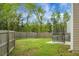 Large, grassy backyard with wood fence provides ample outdoor space and privacy at 7818 Expedition Dr, North Charleston, SC 29420