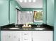A well-lit bathroom featuring double sinks, vanity, and a shower over tub at 7818 Expedition Dr, North Charleston, SC 29420