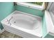 A pristine white bath tub with a window above in this bathroom at 7818 Expedition Dr, North Charleston, SC 29420