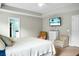 A bedroom with a wall mounted television, a comfortable chair, and carpeted floors at 7818 Expedition Dr, North Charleston, SC 29420