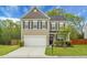 Charming two-story home featuring a well-manicured lawn, neutral siding, black shutters, and an attached two-car garage at 7818 Expedition Dr, North Charleston, SC 29420