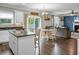 Open-concept kitchen and living room featuring stainless appliances, a center island, and a dining area at 7818 Expedition Dr, North Charleston, SC 29420