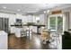 Bright kitchen features stainless appliances, a center island with seating, and a dining area with backyard access at 7818 Expedition Dr, North Charleston, SC 29420