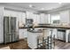 Bright kitchen features stainless appliances and a center island with seating at 7818 Expedition Dr, North Charleston, SC 29420
