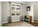Bright room with neutral walls, large window with light curtains, and a wooden cabinet for storage at 7818 Expedition Dr, North Charleston, SC 29420