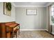 Cozy living room featuring a piano, neutral walls, a decorative window, and a framed quote at 7818 Expedition Dr, North Charleston, SC 29420
