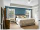This main bedroom features two windows, a dresser and a comfortable bed at 7818 Expedition Dr, North Charleston, SC 29420