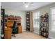 Well-lit office features a ceiling fan, desk, and bookshelves for a professional and organized workspace at 7818 Expedition Dr, North Charleston, SC 29420