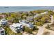 Scenic aerial view of homes near the water, showing the house with a rooftop deck and solar panels at 904 Middle St, Sullivans Island, SC 29482