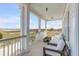 Relaxing balcony featuring comfortable seating and a picturesque view of the water and surrounding landscape at 904 Middle St, Sullivans Island, SC 29482