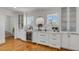 Elegant bar area features white cabinets, marble countertops, and a wine fridge for entertaining at 904 Middle St, Sullivans Island, SC 29482