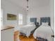 Charming bedroom features two twin beds with blue headboards and warm wood floors at 904 Middle St, Sullivans Island, SC 29482