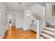 Bright foyer featuring hardwood floors, a staircase, and elegant decor at 904 Middle St, Sullivans Island, SC 29482
