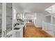 Open hallway with a bar area boasts wood floors and views of the living room and ocean beyond at 904 Middle St, Sullivans Island, SC 29482