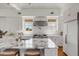 Modern kitchen featuring a marble island, professional-grade appliances, and custom white cabinetry at 904 Middle St, Sullivans Island, SC 29482