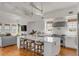 Modern kitchen with white cabinets, marble countertops, an island with seating, and stainless-steel appliances at 904 Middle St, Sullivans Island, SC 29482