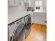 Laundry room with modern washer and dryer, white cabinetry and countertop space at 904 Middle St, Sullivans Island, SC 29482