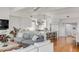 Bright and open-concept living area with an adjacent kitchen, hardwood floors, and neutral color palette at 904 Middle St, Sullivans Island, SC 29482