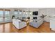 Open living room boasting lots of natural light, hardwood floors and fireplace at 904 Middle St, Sullivans Island, SC 29482