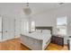 Bright main bedroom with hardwood floors, two bedside tables, and neutral decor at 904 Middle St, Sullivans Island, SC 29482
