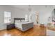 Spacious main bedroom featuring hardwood floors, a chandelier, and neutral decor at 904 Middle St, Sullivans Island, SC 29482