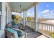 Inviting porch with seating offers a relaxing outdoor space with views of the surrounding landscape at 904 Middle St, Sullivans Island, SC 29482