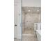 Modern walk-in shower with marble tile surround, glass door, and sleek fixtures at 904 Middle St, Sullivans Island, SC 29482