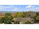 Water view through the trees, featuring boats and a red roofed home nearby at 904 Middle St, Sullivans Island, SC 29482