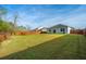 A large backyard with green lawn, showcasing a wooden fence and rear of home, offering serene privacy at 9723 Flooded Field Dr, Ladson, SC 29456